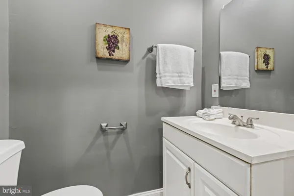 a bathroom with a sink mirror vanity and toilet