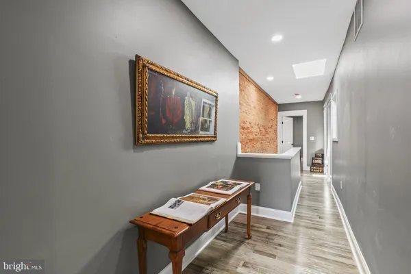a view of a hallway with seating area