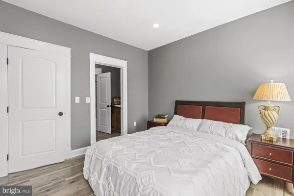 a bedroom with a bed and a lamp