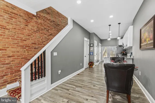 a dining room with furniture and wooden floor