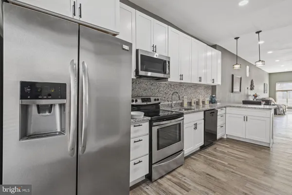 a kitchen with stainless steel appliances a refrigerator sink and stove