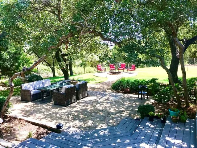 a view of a backyard with sitting area