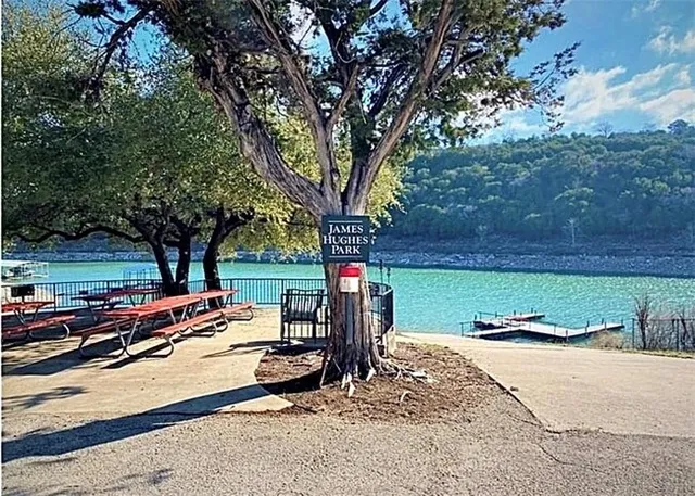 a sign board with a yard and lake view