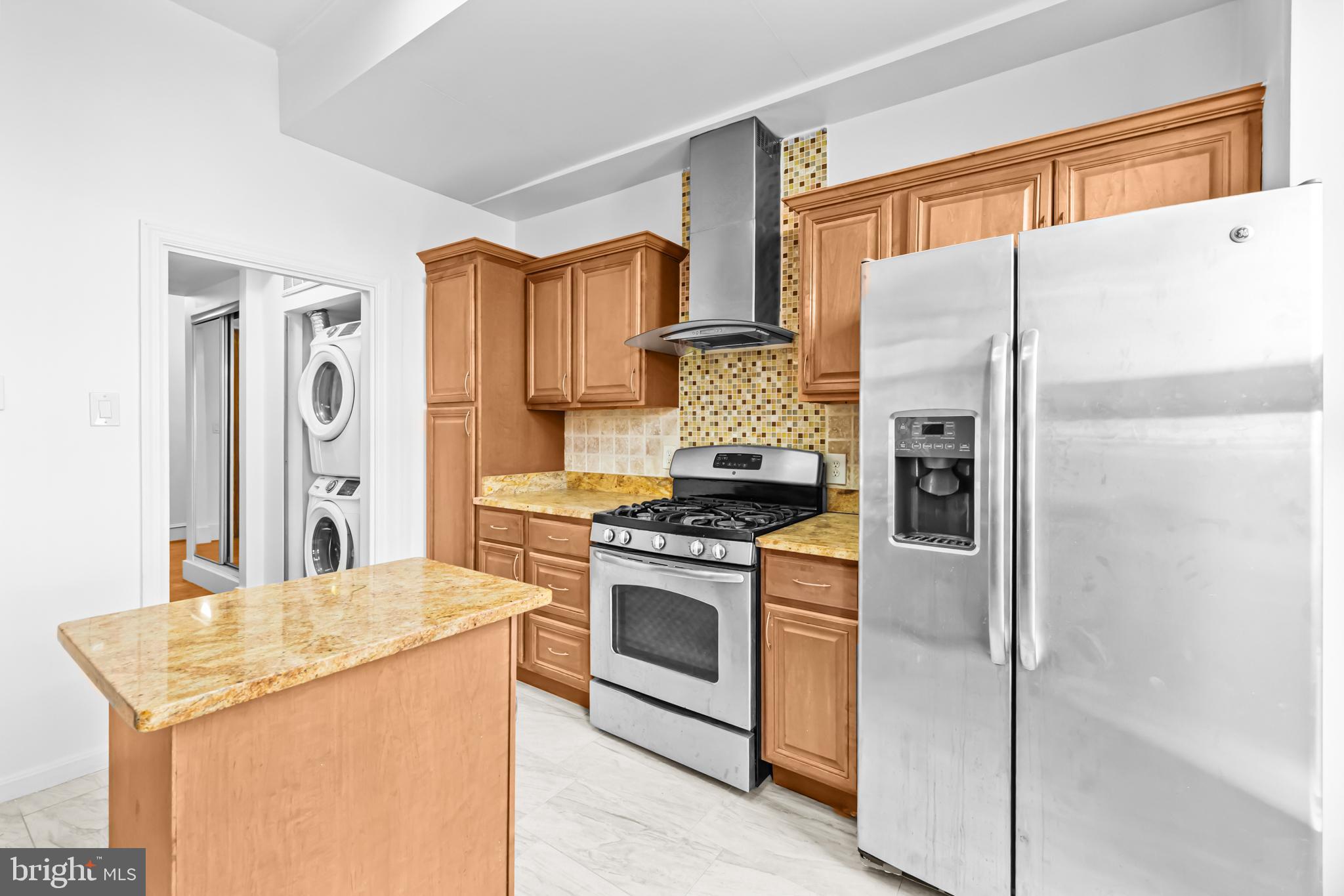 1021 Columbia Road Northwest Washington, DC 20001 - Photo 16 of 55 a kitchen with stainless steel appliances granite countertop a refrigerator and a stove