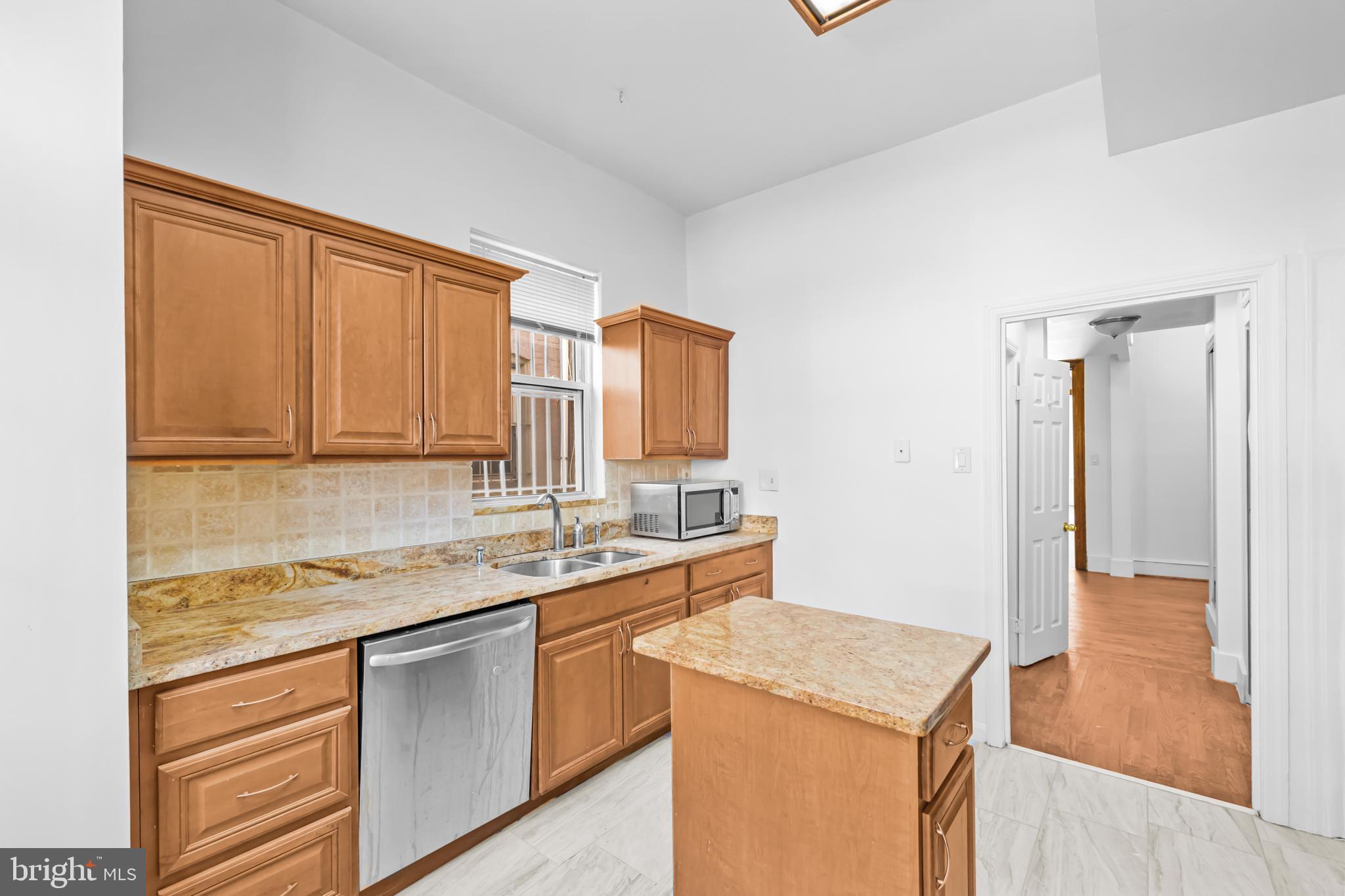 1021 Columbia Road Northwest Washington, DC 20001 - Photo 17 of 55 a kitchen that has a sink and a stove