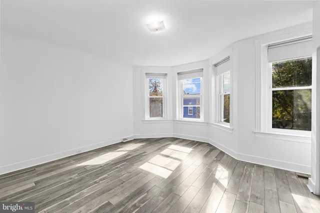 a view of room with wooden floor