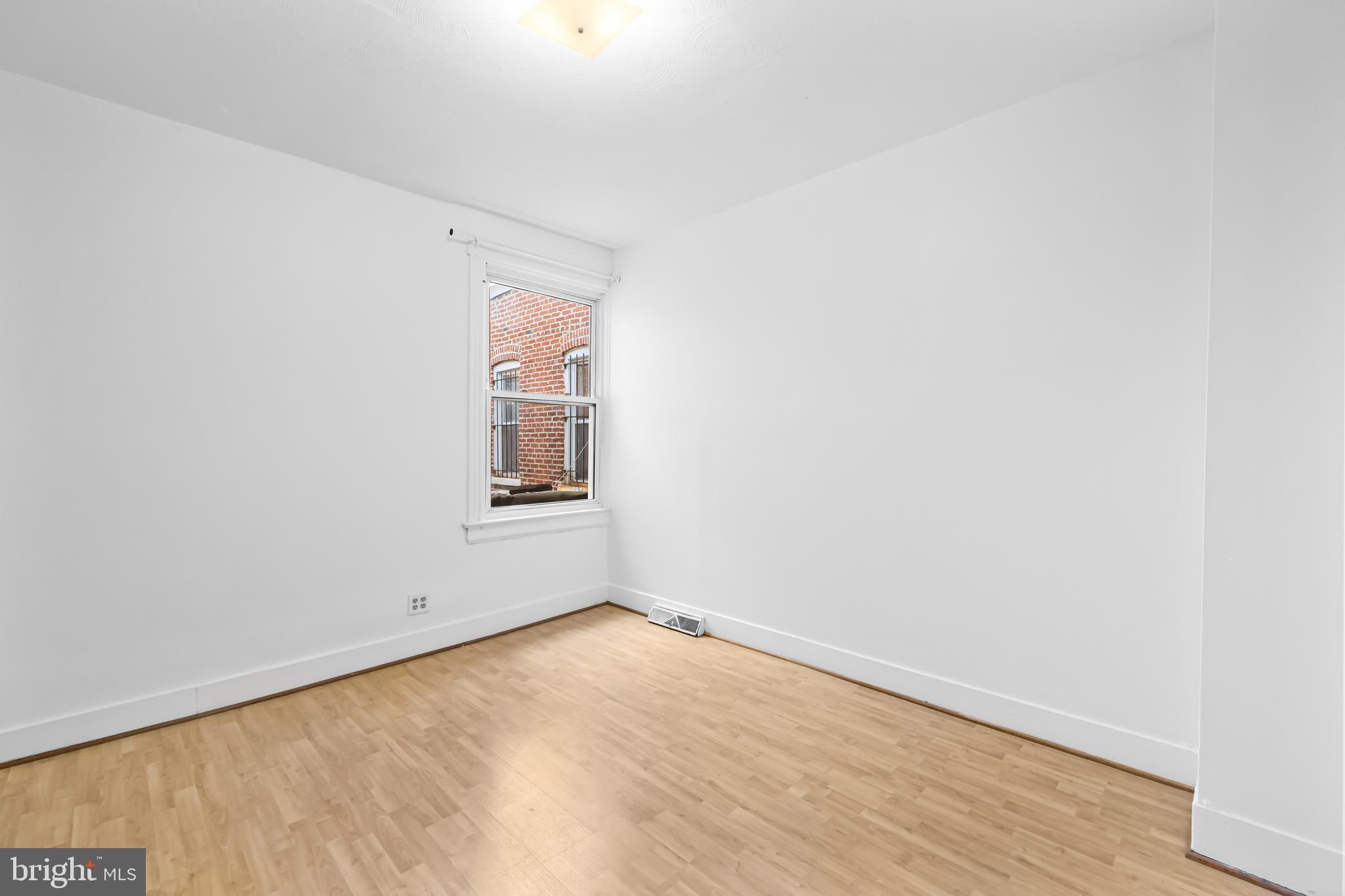 1021 Columbia Road Northwest Washington, DC 20001 - Photo 23 of 55 a view of empty room with wooden floor and fan