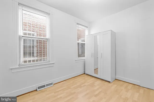 a view of a room with wooden floor