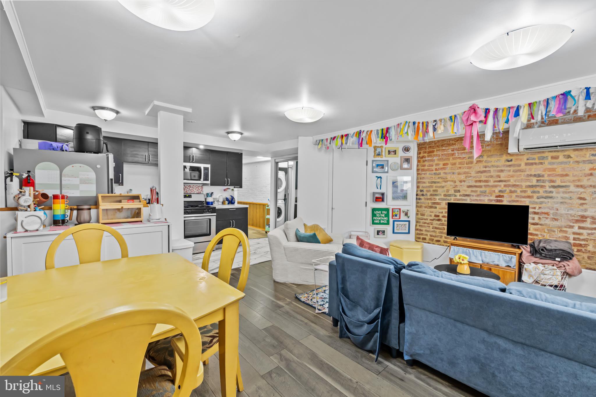 1021 Columbia Road Northwest Washington, DC 20001 - Photo 30 of 55 a living room with furniture a flat screen tv and a fireplace