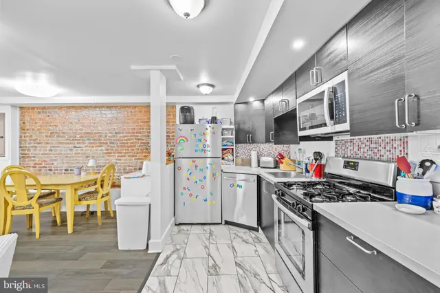 a living room with furniture and a kitchen