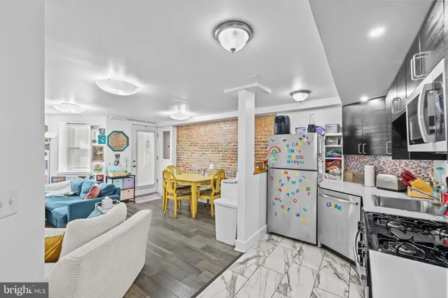 a living room with furniture and a book shelf