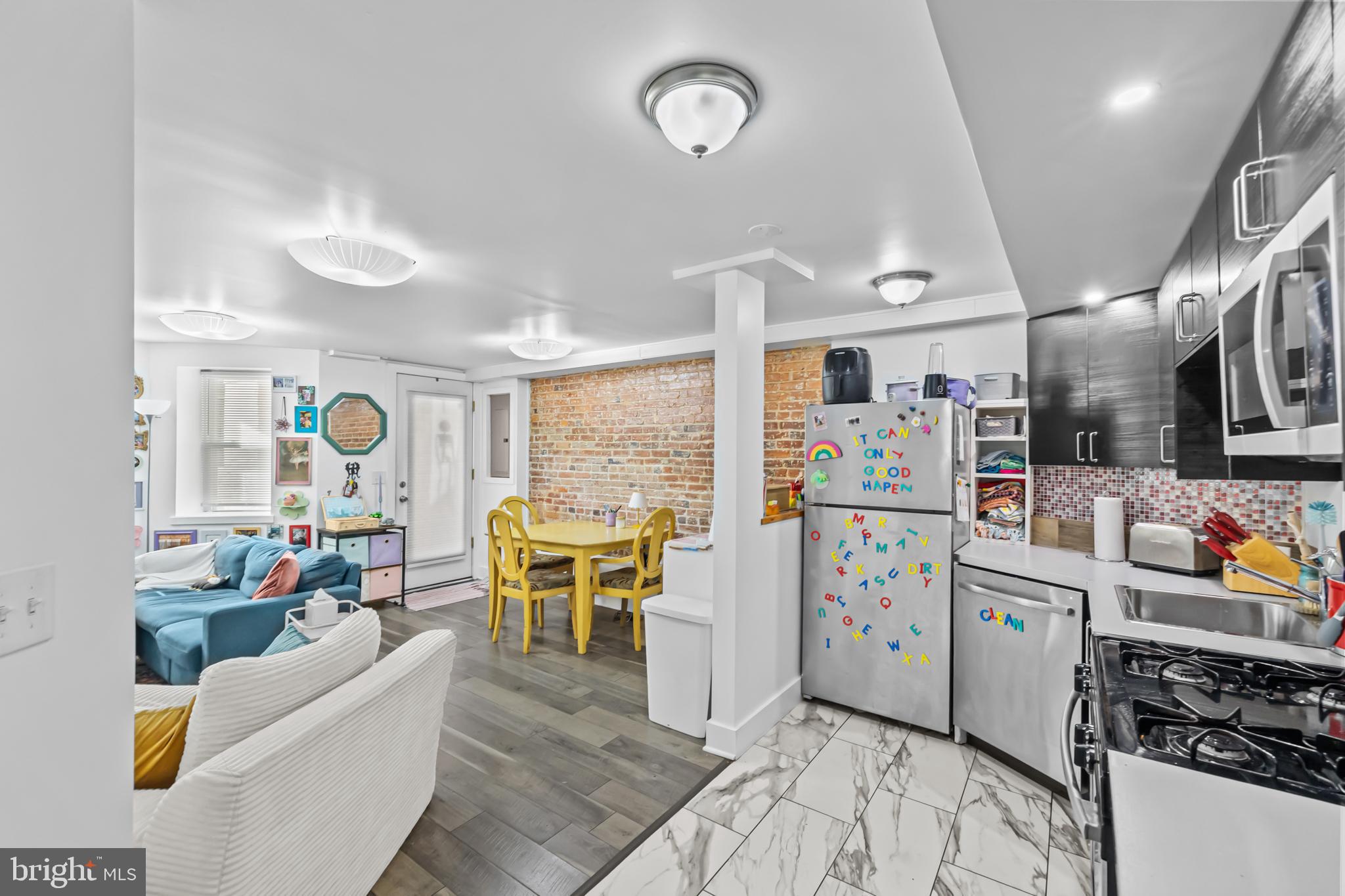 1021 Columbia Road Northwest Washington, DC 20001 - Photo 34 of 55 a living room with furniture and a kitchen