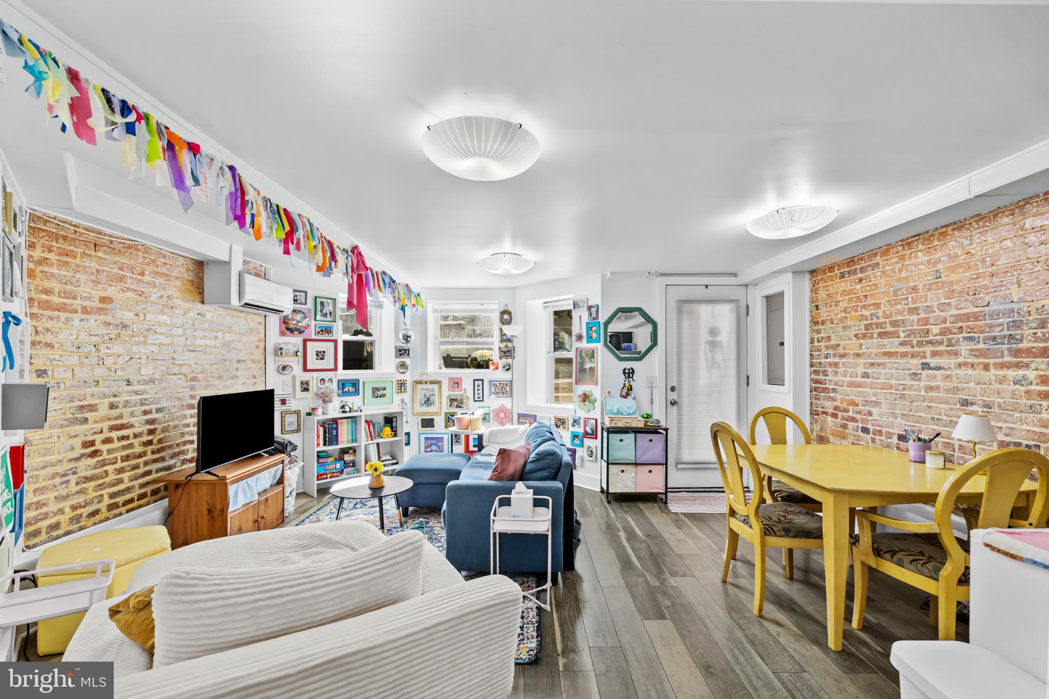 1021 Columbia Road Northwest Washington, DC 20001 - Photo 38 of 55 a living room with fireplace furniture and a flat screen tv