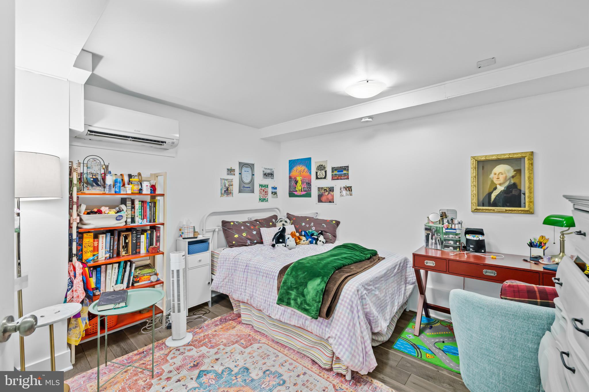 1021 Columbia Road Northwest Washington, DC 20001 - Photo 42 of 55 a bedroom with a bed and a book shelf