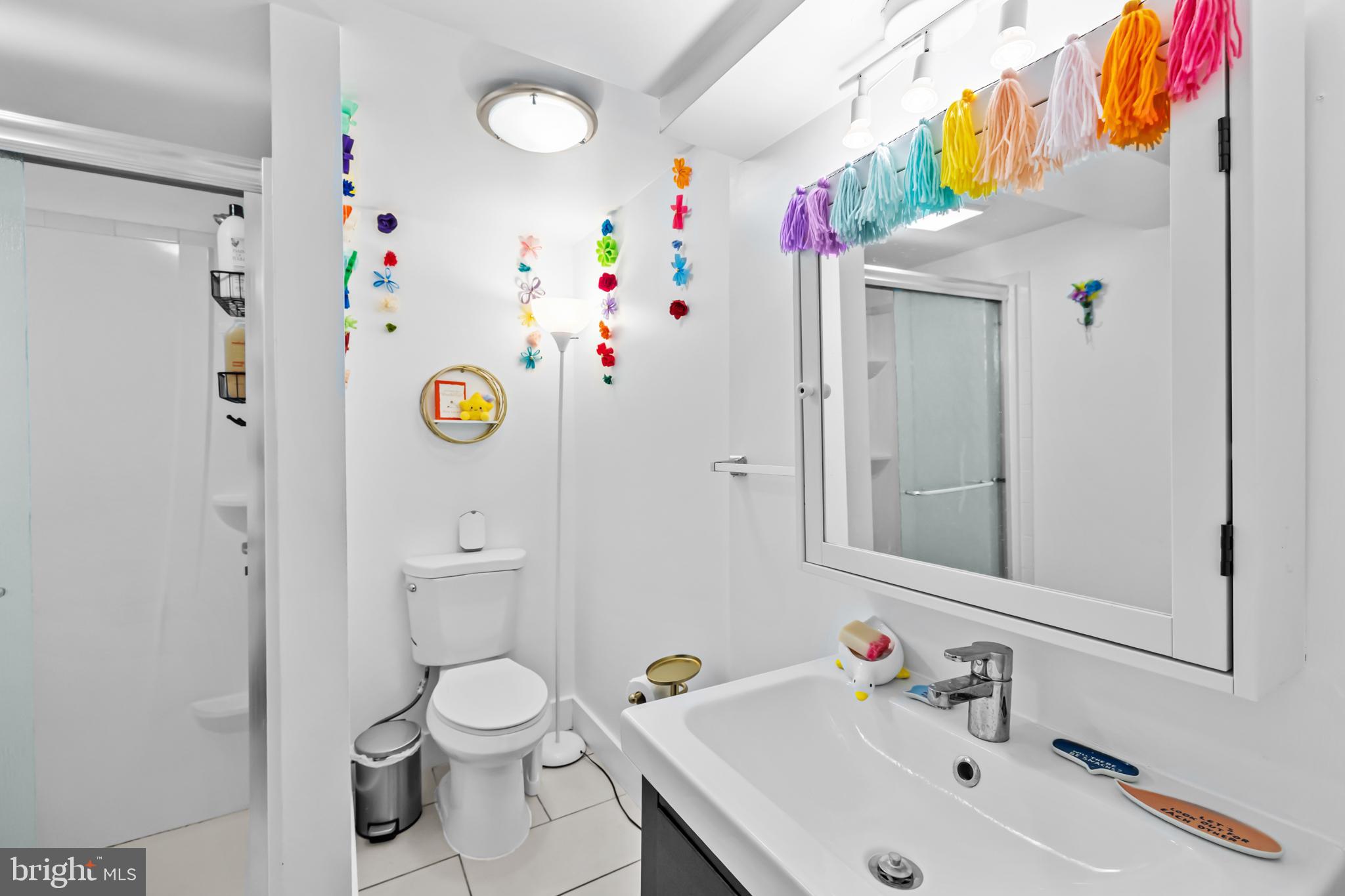 1021 Columbia Road Northwest Washington, DC 20001 - Photo 45 of 55 a bathroom with a sink a toilet and a mirror