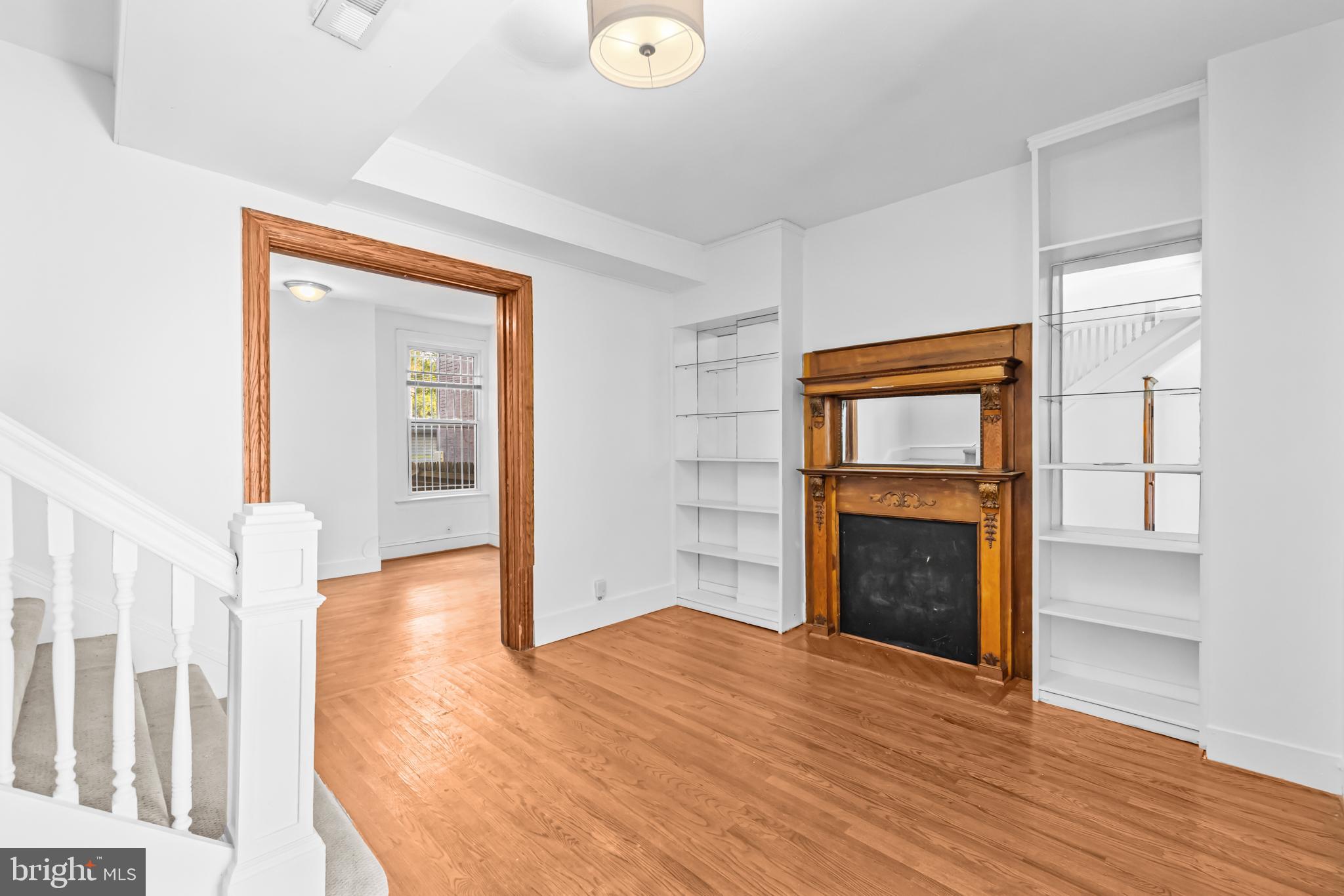 1021 Columbia Road Northwest Washington, DC 20001 - Photo 7 of 55 a view of empty room with wooden floor and fireplace