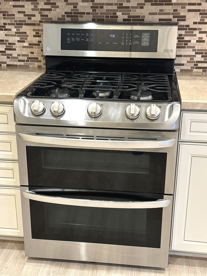 5102 Monroe Street Matteson, IL 60443 - Photo 20 of 54 a stove top oven sitting inside of a kitchen