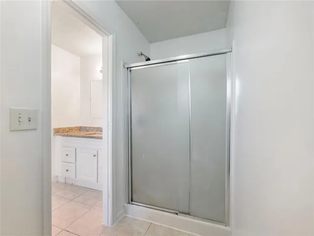 a bathroom with a glass shower door