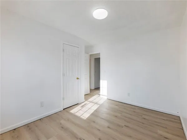 a view of an empty room and wooden floor