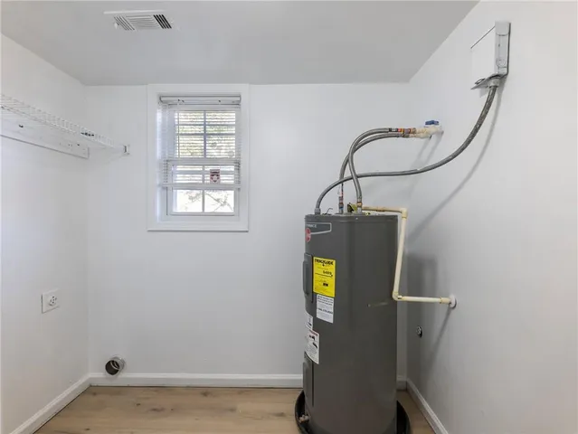 a view of storage and utility room with a window