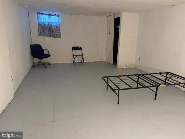 a living room with furniture and a air conditioner vent