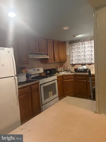 a kitchen with a sink a stove and refrigerator