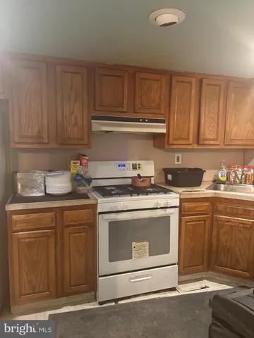 a kitchen with granite countertop cabinets stainless steel appliances and a sink
