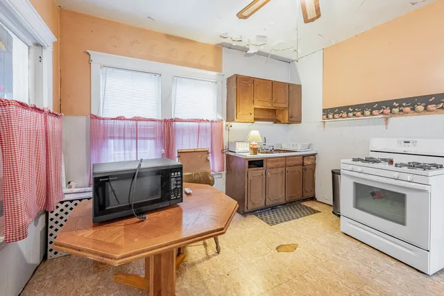 a kitchen with a stove a sink and a microwave