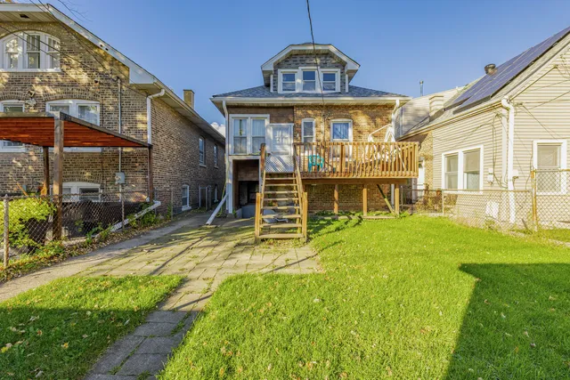 a view of a big building with a big yard and large trees