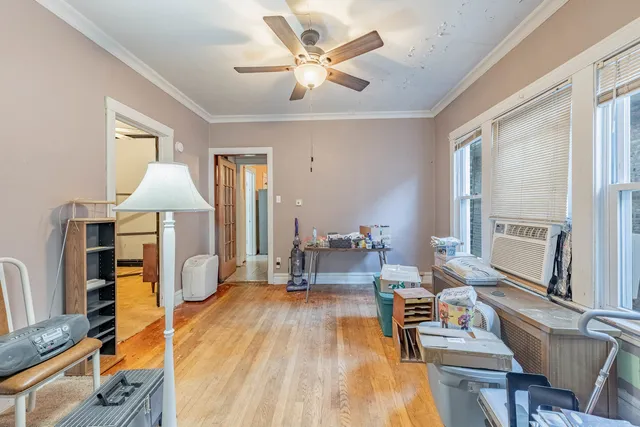a living room with furniture a table and wooden floor