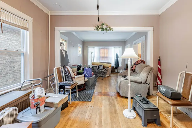 a living room with furniture chandelier and a flat screen tv