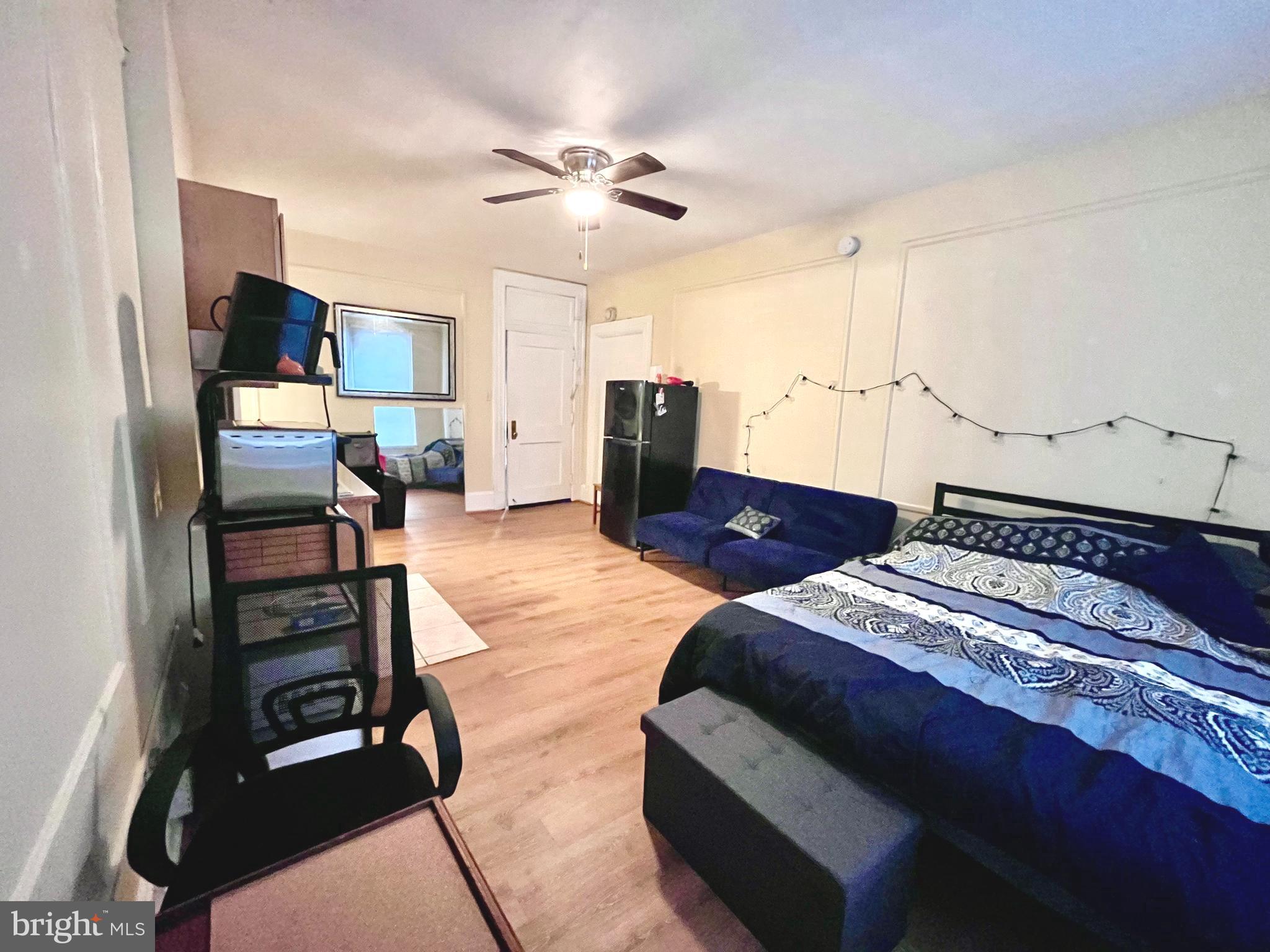 1324 Locust Street, Unit 314 Philadelphia, PA 19107 - Photo 3 of 7 a bedroom with a bed and furniture