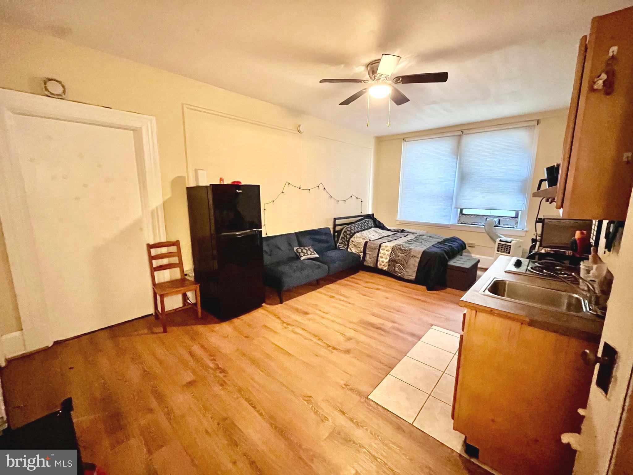 1324 Locust Street, Unit 314 Philadelphia, PA 19107 - Photo 5 of 7 a bed room with a bed and a television