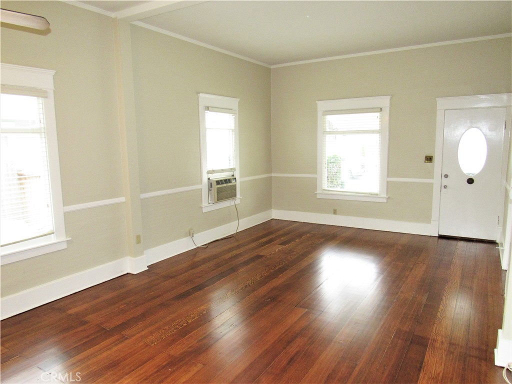 478 South Grand Street Orange, CA 92866 - Photo 4 of 10 an empty room with wooden floor and windows