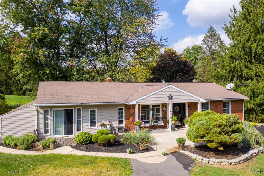 a front view of a house with garden and porch