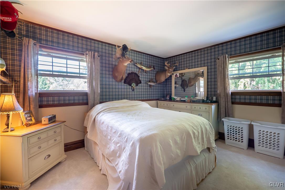 130 County Line Road Riegelsville, PA 18077 - Photo 26 of 40 a spacious bedroom with a bed and a dresser next to a window