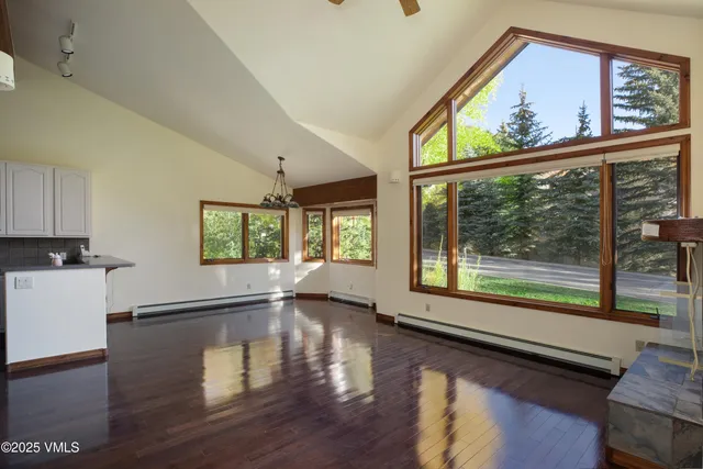 a view of a park with potted plants and large trees