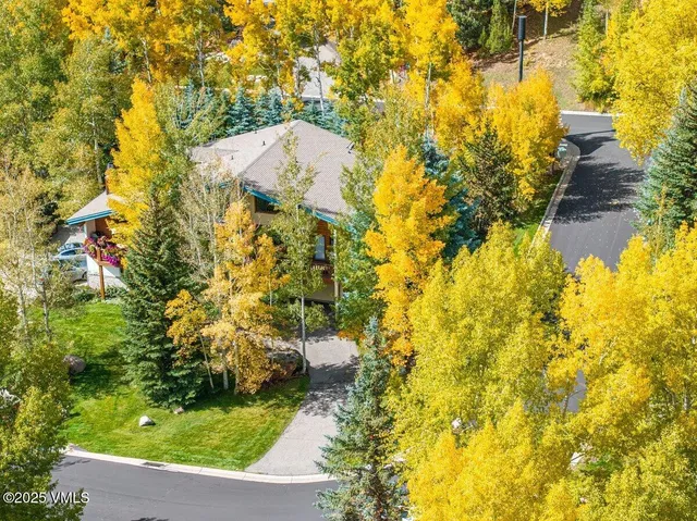 an aerial view of a house with a swimming pool