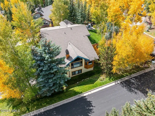 a view of house with yard and green space