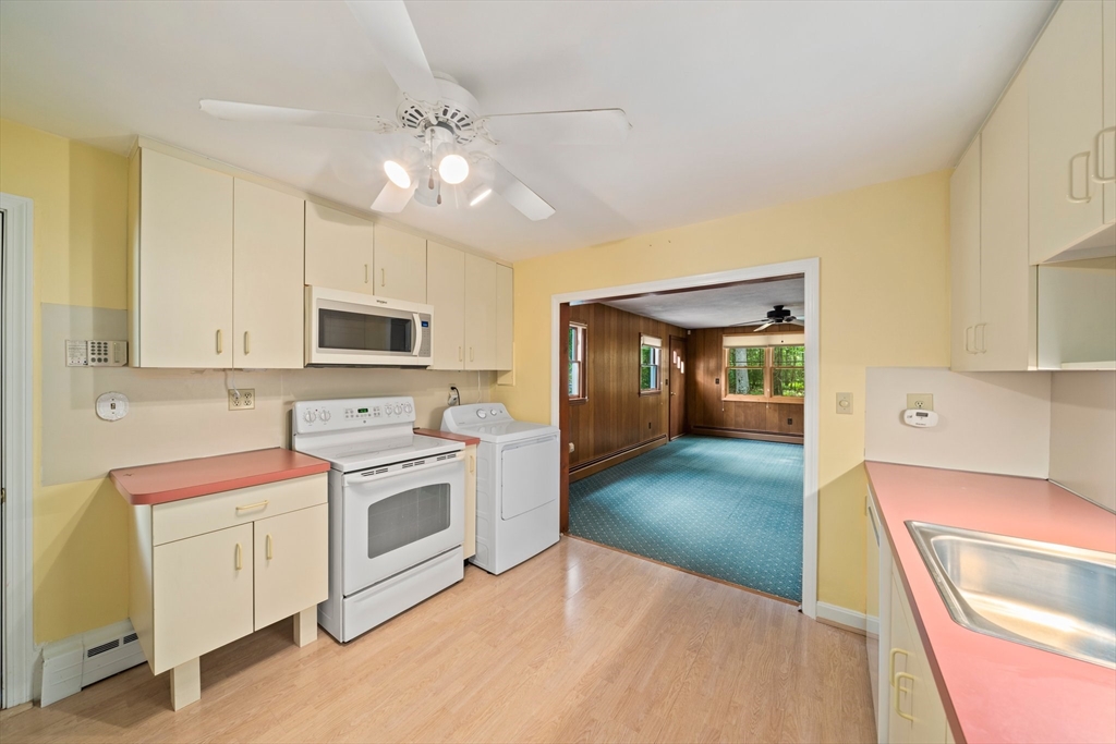 34 Birchcroft Road Canton, MA 02021 - Photo 7 of 31 a view of a kitchen with a sink and dishwasher with white cabinets