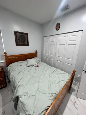 a bed sitting in a bedroom and dressers