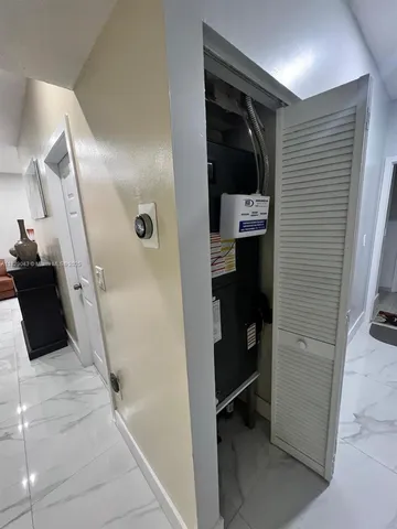 a utility room with dryer washer and a refrigerator