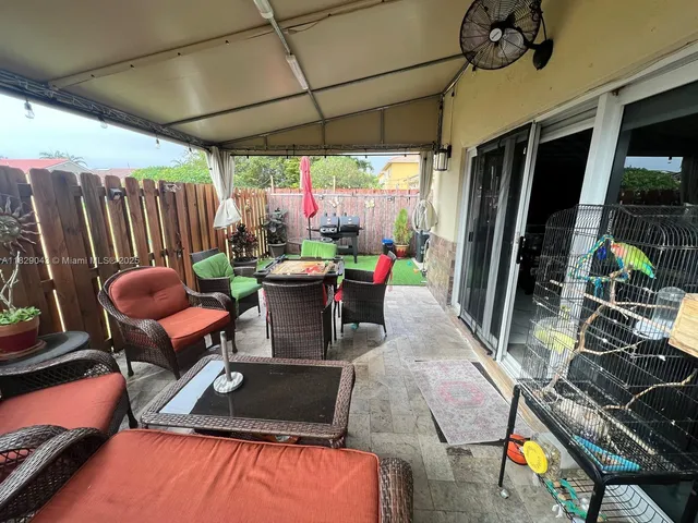a outdoor sitting area with furniture and wooden floor