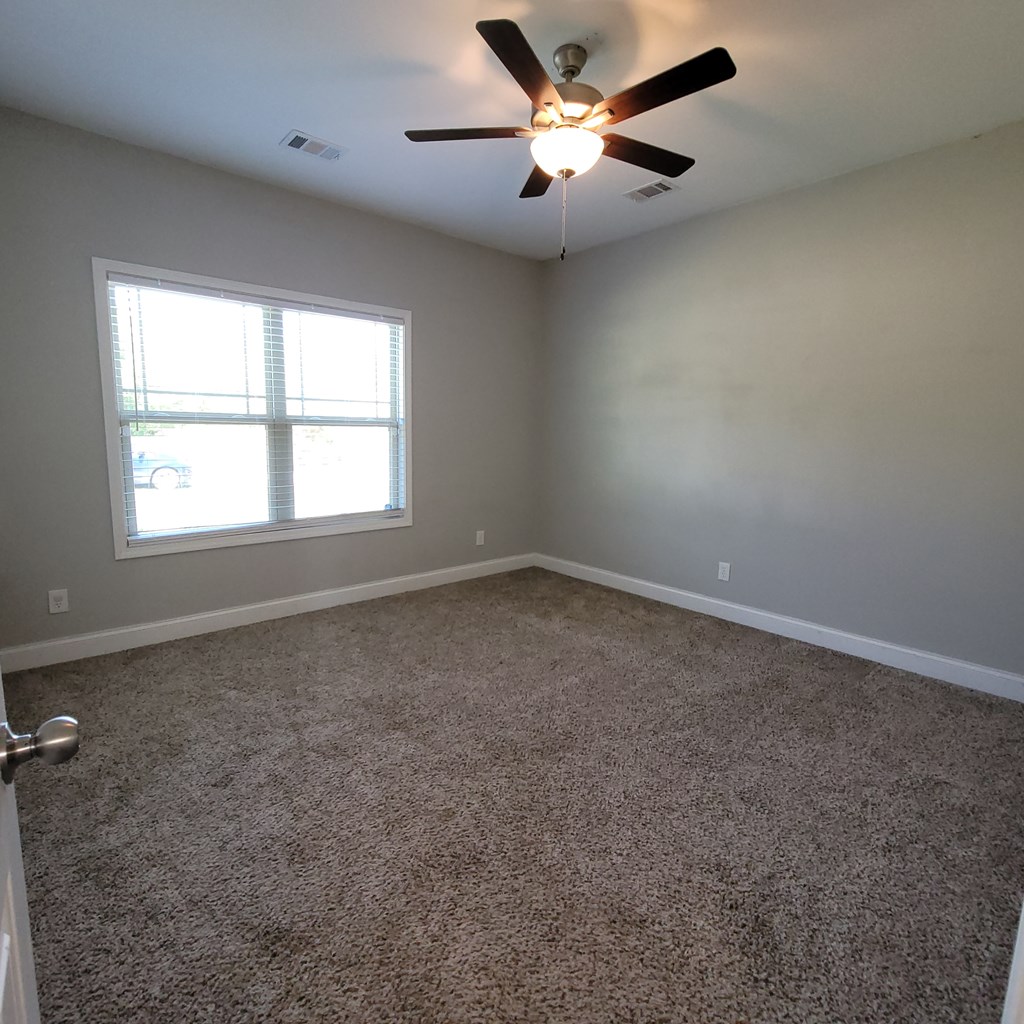 19 Fast Lane Seale, AL 36875 - Photo 11 of 18 an empty room with a window and a fan