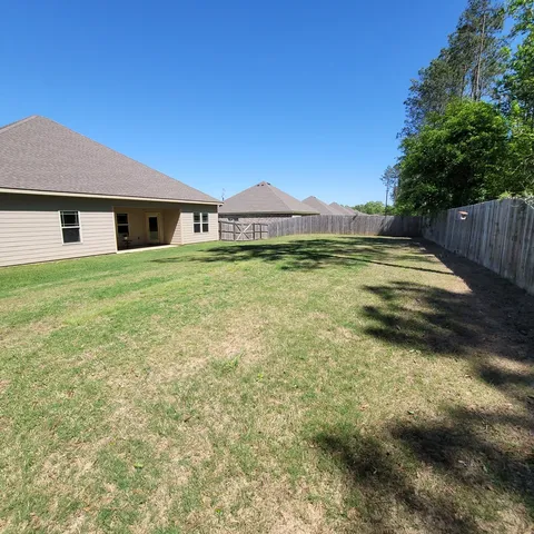 a view of a house with a yard and garage
