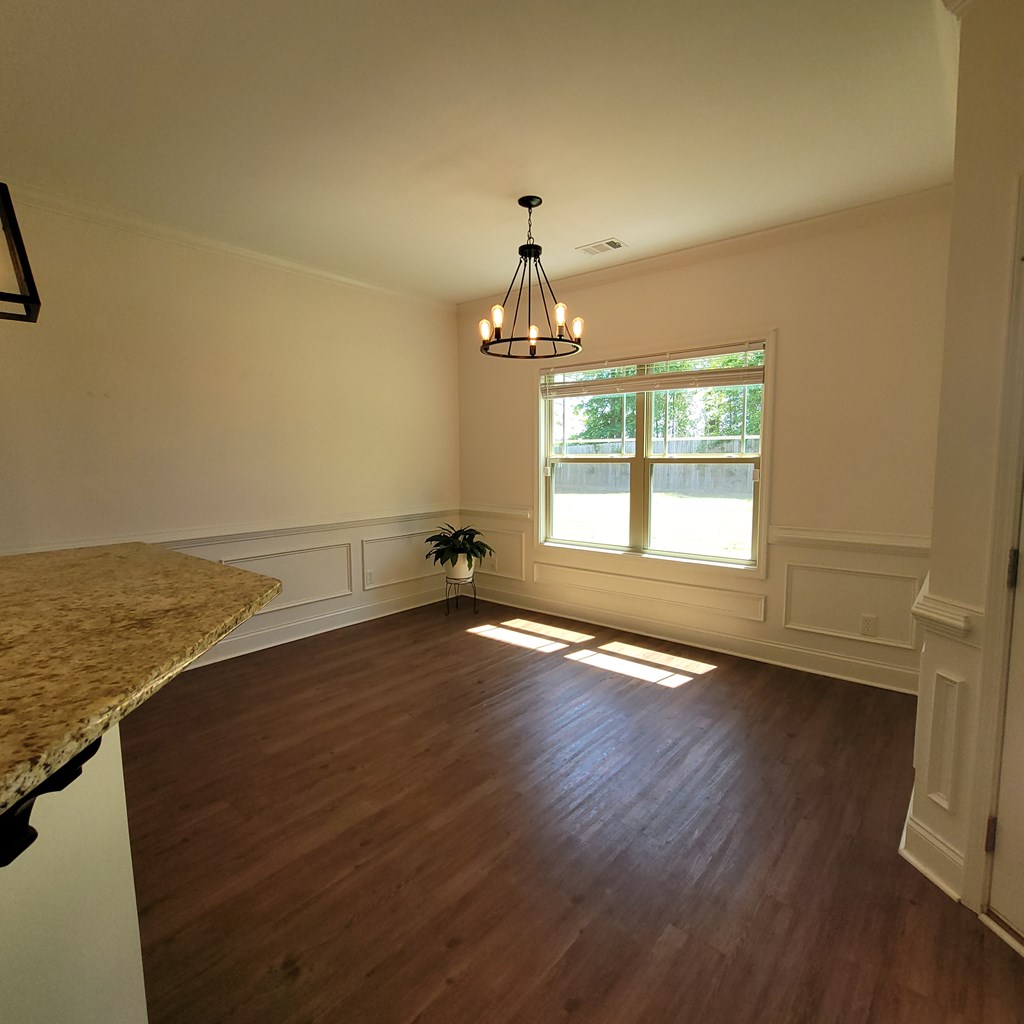 19 Fast Lane Seale, AL 36875 - Photo 5 of 18 an empty room with wooden floor chandelier and windows
