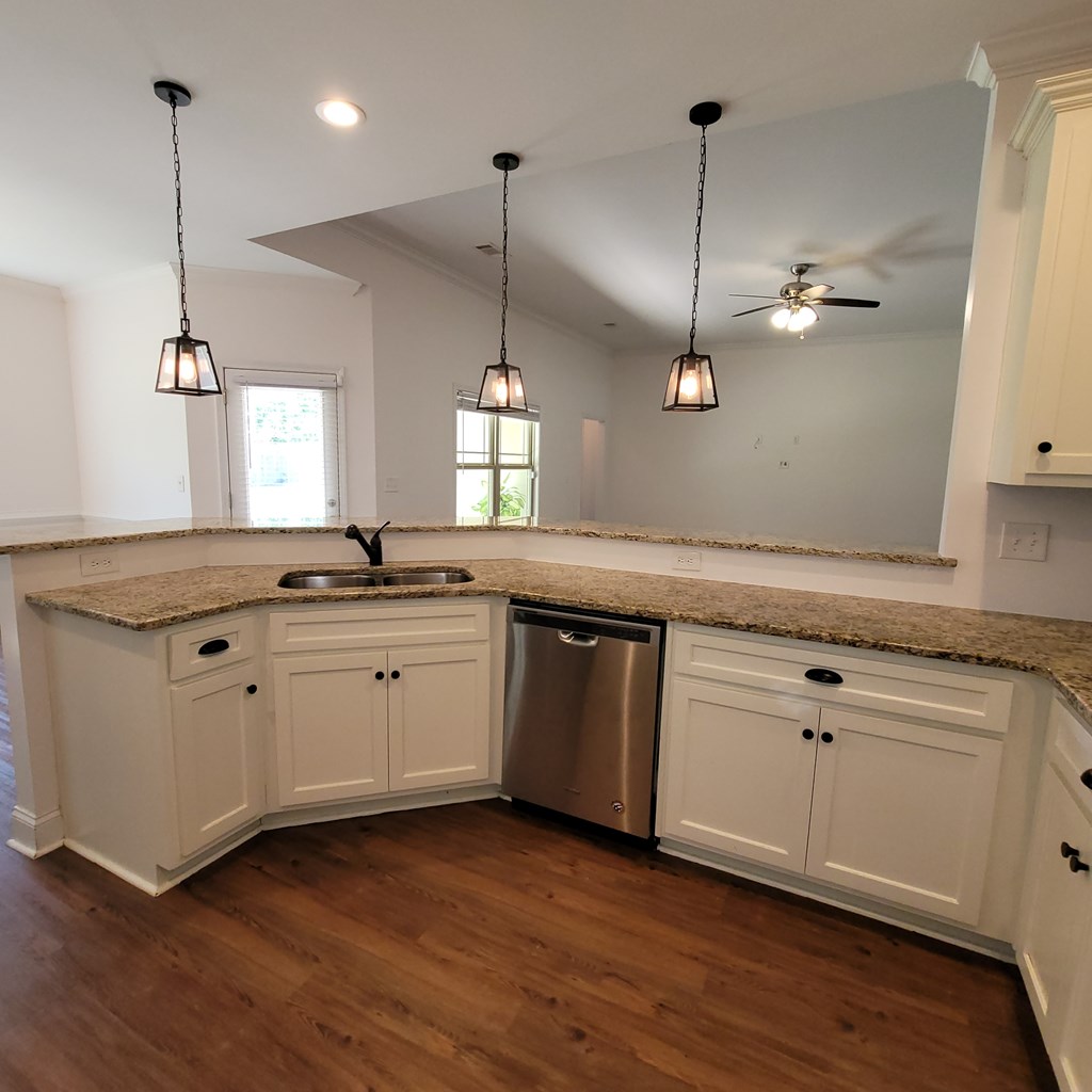 19 Fast Lane Seale, AL 36875 - Photo 6 of 18 a kitchen with a sink window and wooden floor