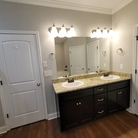 a bathroom with a double vanity sink and a mirror