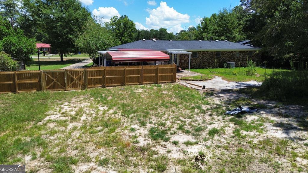 108 Plum Street Dublin, GA 31021 - Photo 6 of 33 a view of a backyard with a garden and entertaining space
