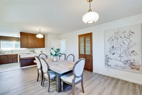 a view of a dining room with furniture and wooden floor